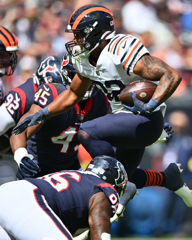 Sep 25, 2022; Chicago, Illinois, USA; Chicago Bears running back David Montgomery (32) leaps through the line for a five yard gain in the first quarter against the Houston Texans at Soldier Field. Mandatory Credit: Jamie Sabau-USA TODAY