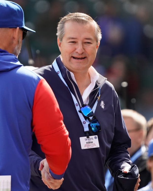 Oct 2, 2022; Chicago, Illinois, USA; Chicago Cubs owner Tom Ricketts, right, talks with manager David Ross (3) before the game against the Cincinnati Reds at Wrigley Field.