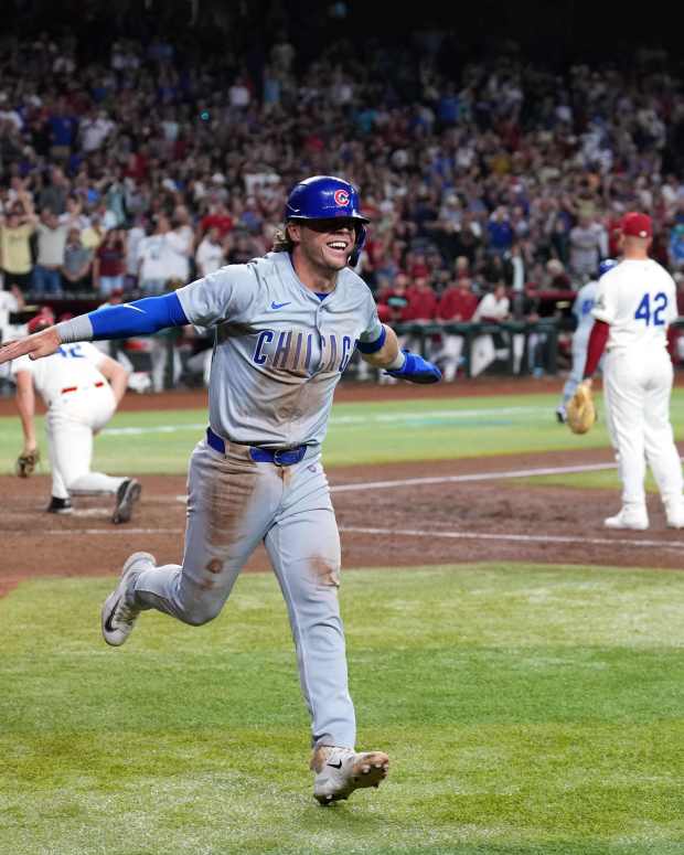 Apr 15, 2024; Phoenix, Arizona, USA; Chicago Cubs second baseman Nico Hoerner celebrates after scoring a run against the Arizona Diamondbacks during the ninth inning at Chase Field. All players wore number 42 to commemorate Jackie Robinson Day.