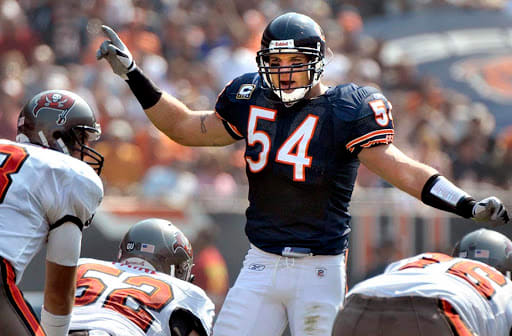 RON JOHNSON/JOURNAL STAR Brian Urlacher, directs the Bears defense in a game in 2008 at Soldier Field. Urlacher played 13 seasons with the Bears.