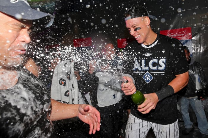 Oct 18, 2022; Bronx, New York, USA; New York Yankees right fielder Aaron Judge (right) and designated hitter Giancarlo Stanton (left) celebrate in the clubhouse after their win against the Cleveland Guardians in game five of the ALDS for the 2022 MLB Playoffs at Yankee Stadium.