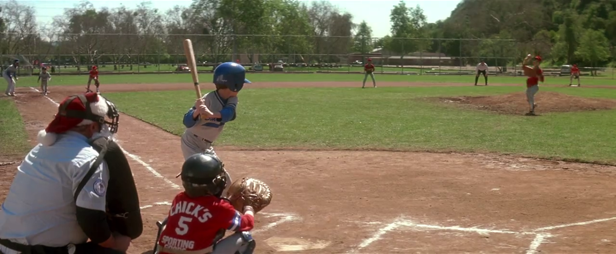 The baseball game from the beginning of the movie Hook. It shows the character Jack Panning as the batter. The umpire is wearing a Santa hat because it is a the 'Santa Series' tournament.