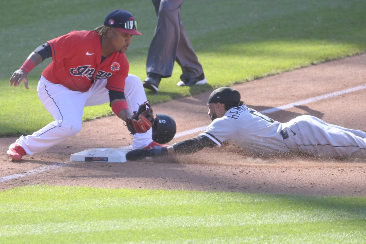 May 31, 2021; Cleveland, Ohio, USA; Chicago White Sox center fielder Billy Hamilton (0) steals third base beside Cleveland Indians third baseman Jose Ramirez (11) in the eighth inning at Progressive Field.