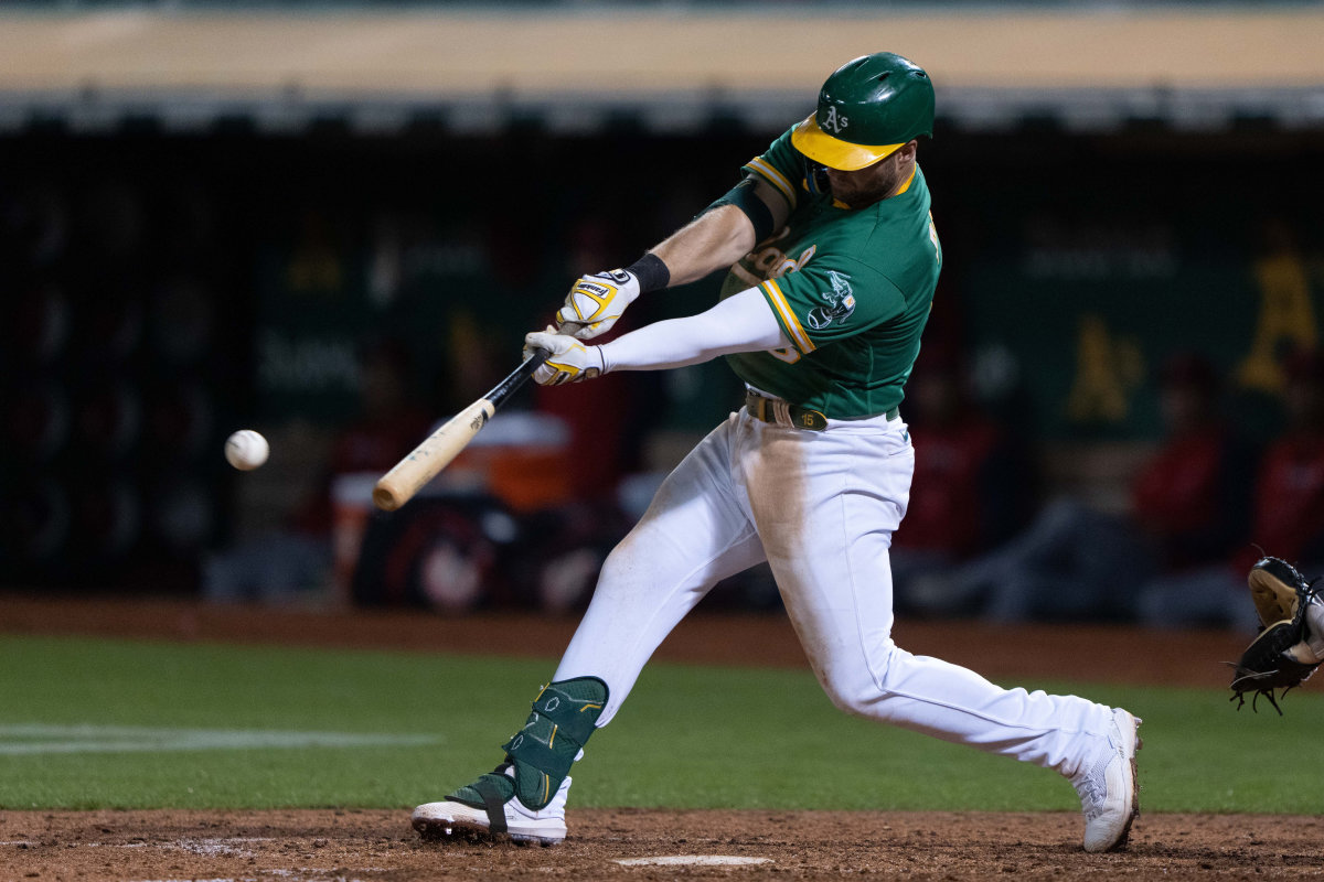 Oct 4, 2022; Oakland, California, USA; Oakland Athletics first baseman Seth Brown (15) hits a RBI single during the eighth inning against the Los Angeles Angels at RingCentral Coliseum.