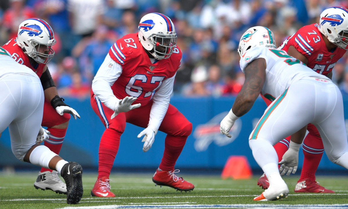 Buffalo Bills guard Quinton Spain, center, prepares to block Miami Dolphins defensive tackle Davon Godchaux, right, in the first half of an NFL football game, Sunday, Oct. 20, 2019, in Orchard Park, N.Y. (AP Photo/Adrian Kraus)