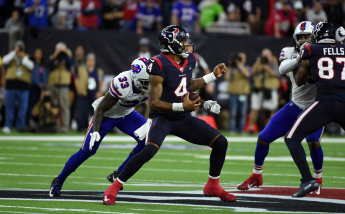 Houston Texans quarterback Deshaun Watson (4) avoids being sacked by the Buffalo Bills' Siran Neal (33) during overtime of an NFL wild-card playoff football game Saturday, Jan. 4, 2020, in Houston. The Texans won 22-19 in overtime. (AP Photo/Eric Christian Smith)