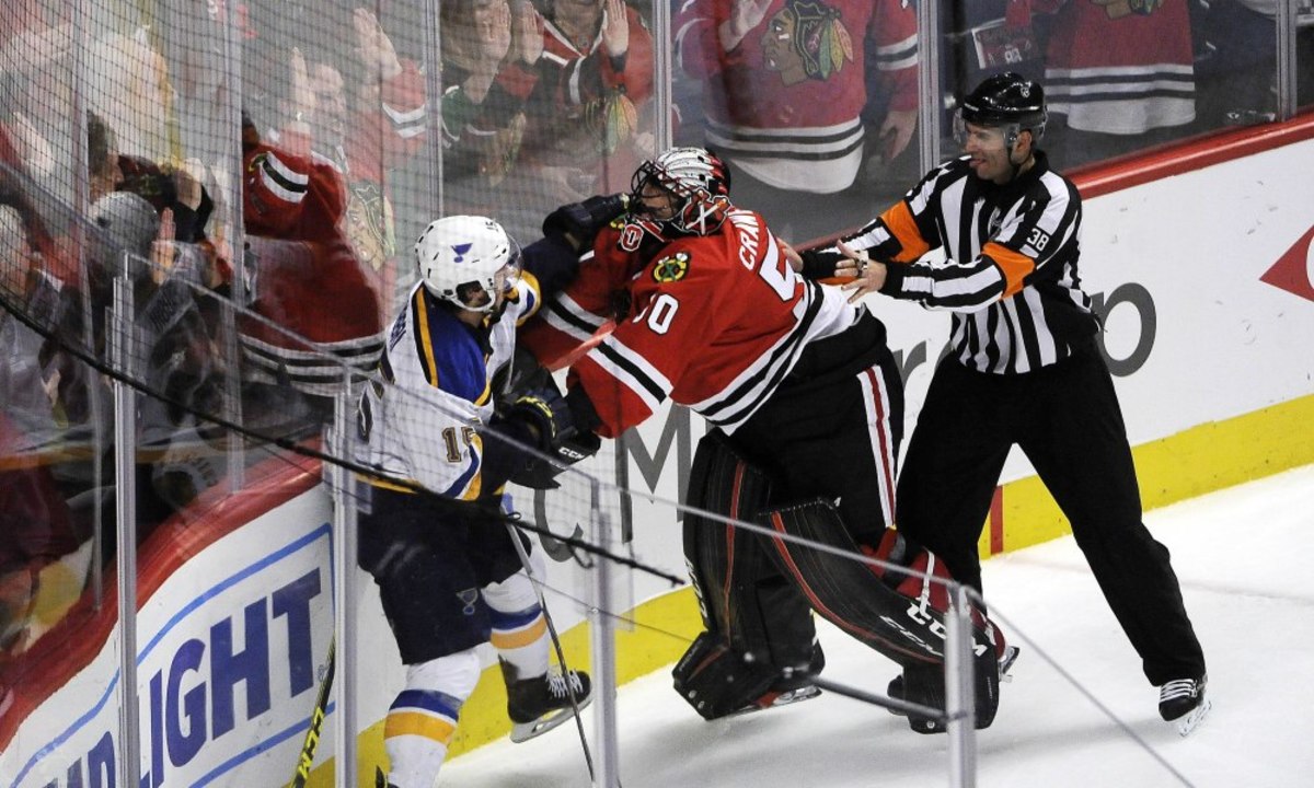 Apr 19, 2016; Chicago, IL, USA; St. Louis Blues center Robby Fabbri (15) and Chicago Blackhawks goalie Corey Crawford (50) fight during the second period in game four of the first round of the 2016 Stanley Cup Playoffs at United Center. Mandatory Credit: David Banks-USA TODAY Sports ORG XMIT: USATSI-267978 ORIG FILE ID:  20160419_ajw_bb6_229.jpg
