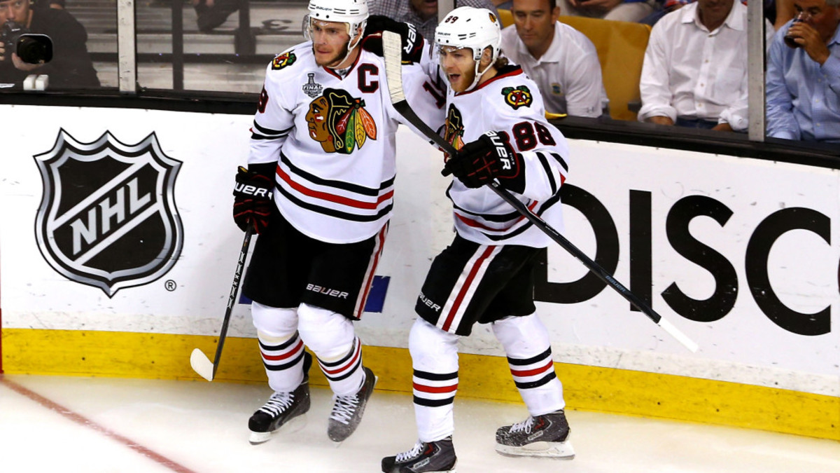 BOSTON, MA - JUNE 24:  Jonathan Toews #19 of the Chicago Blackhawks celebrates with teammate Patrick Kane #88 after Toews scored a goal in the second period against Tuukka Rask #40 of the Boston Bruins in Game Six of the 2013 NHL Stanley Cup Final at TD Garden on June 24, 2013 in Boston, Massachusetts.  (Photo by Elsa/Getty Images)
