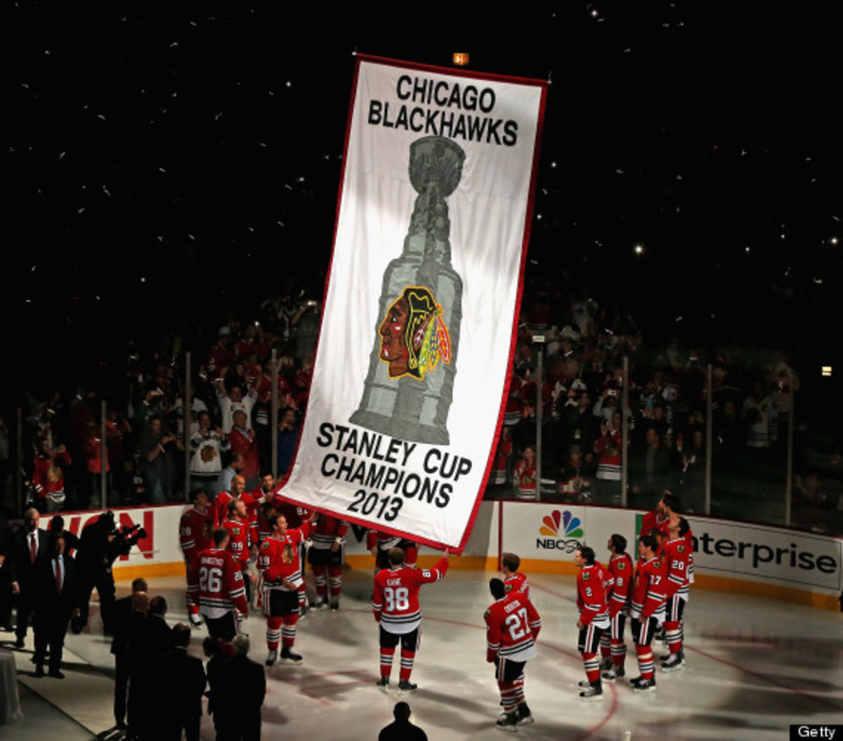 CHICAGO, IL - OCTOBER 01: Members of the Chicago Blackhawks watch as the 2013 Stanley Cup Championship banner is hung during a ceremony before taking on the Washington Capitals at the United Center on October 1, 2013 in Chicago, Illinois. (Photo by Jonathan Daniel/Getty Images)