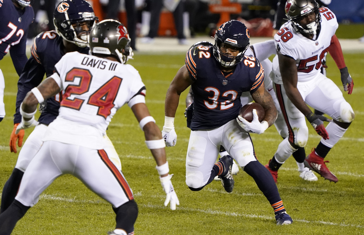 Oct 8, 2020; Chicago, Illinois, USA; Chicago Bears running back David Montgomery (32) rushes the ball against Tampa Bay Buccaneers cornerback Carlton Davis (24) during the fourth quarter at Soldier Field. Mandatory Credit: Mike Dinovo-USA TODAY Sports
