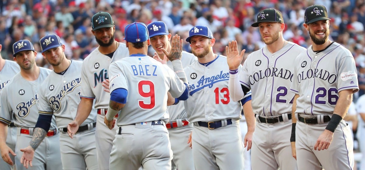 CLEVELAND, OHIO - JULY 09: Javier Baez #9 of the Chicago Cubs and the National League greets teammates as he is introduced during the 2019 MLB All-Star Game, presented by Mastercard at Progressive Field on July 09, 2019 in Cleveland, Ohio. (Photo by Gregory Shamus/Getty Images)