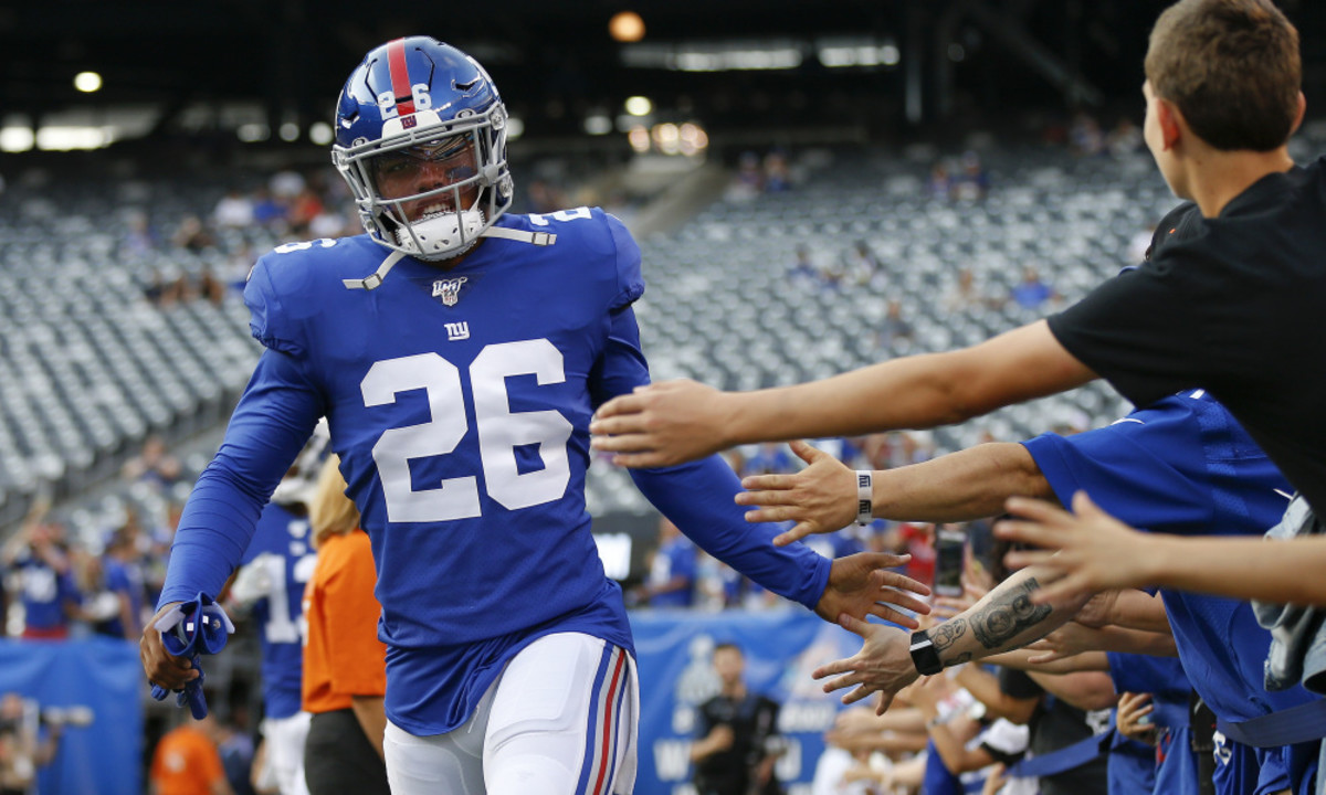 New York Giants running back Saquon Barkley (26) greets fans before an NFL football game against the Chicago Bears, Friday, Aug. 16, 2019, in East Rutherford, N.J. (AP Photo/Adam Hunger)