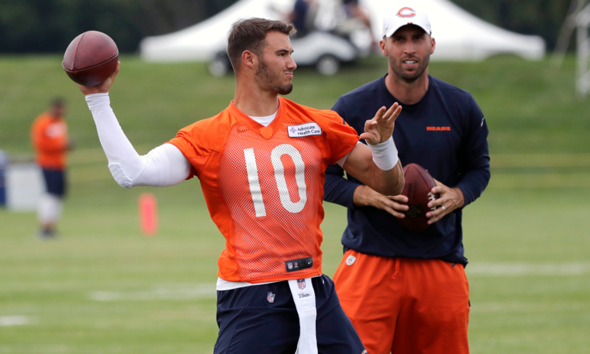 Chicago Bears quarterback Mitchell Trubisky, left, throws a ball as quarterbacks coach Dave Ragone looks on during an NFL football training camp in Bourbonnais, Ill., Friday, July 26, 2019. (AP Photo/Nam Y. Huh)