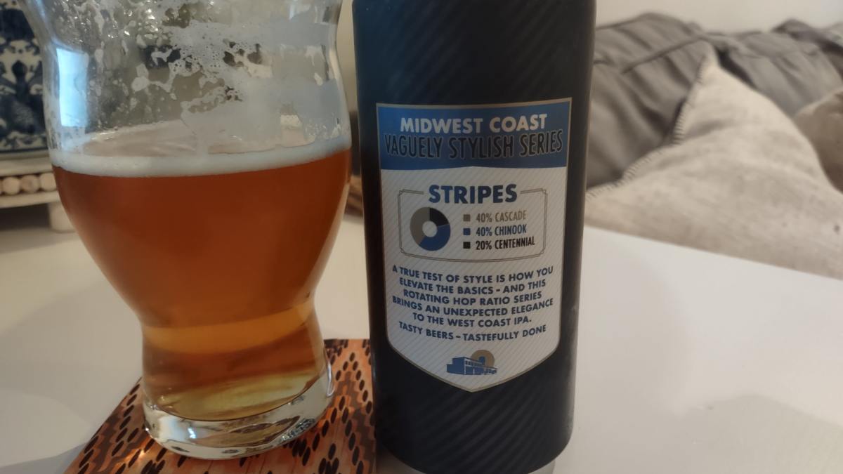 A picture of the midwest coast vaguely stylish bottle and partly filled glass. The can displays the percentage of each type of hops in this batch. 40% Cascade, 40% Chinook, and 20% Centennial.