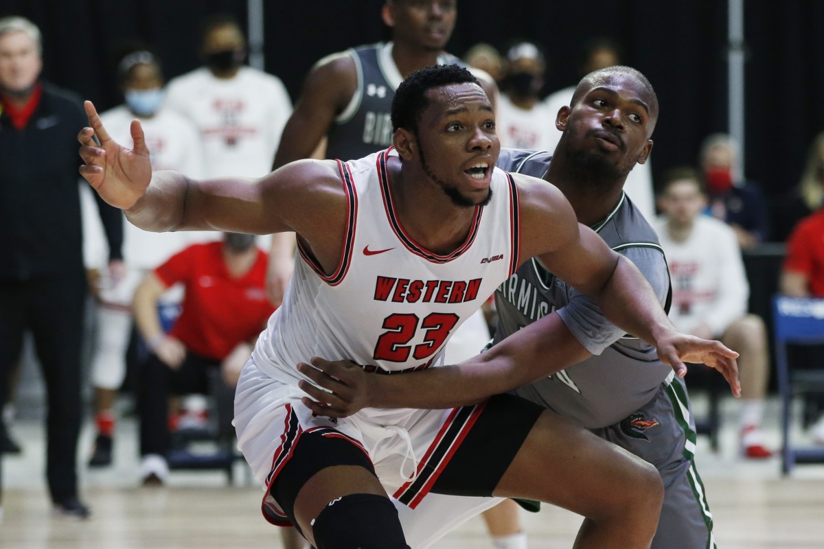 Mar 12, 2021; Frisco, Texas, USA; Western Kentucky Hilltoppers center Charles Bassey (23) is guarded by UAB Blazers forward Simeon Kirkland (10) during the second half at Ford Center at The Star. Mandatory Credit: Tim Heitman-USA TODAY Sports