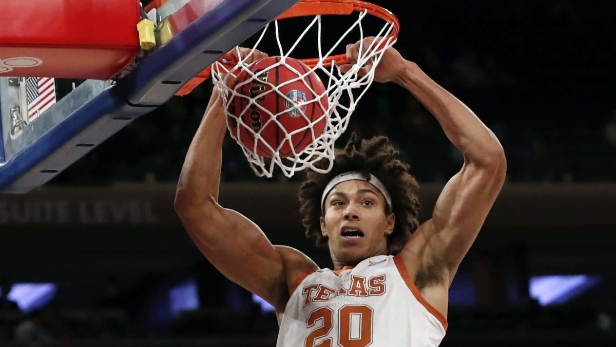Texas forward Jericho Sims (20) dunks during the first round of the 2K Empire Classic college basketball tournament against Georgetown, Thursday, Nov. 21, 2019, in New York. (AP Photo/Kathy Willens)