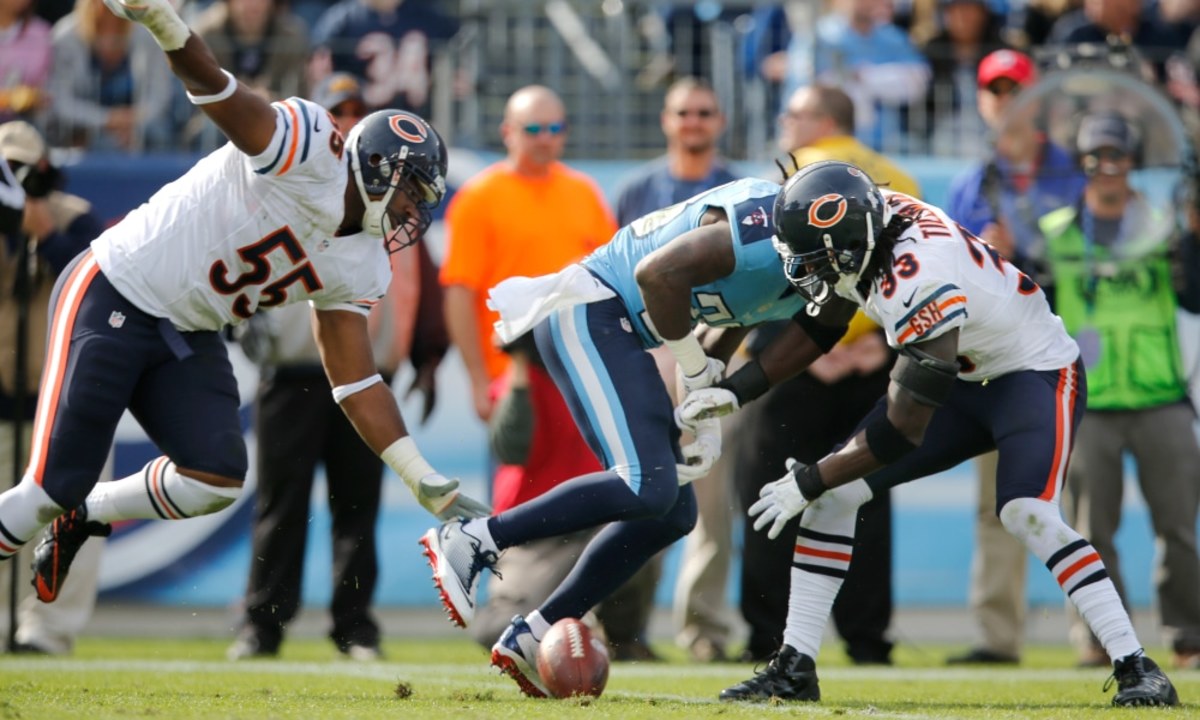 Chicago Bears cornerback Charles Tillman (33) forces a fumble by Tennessee Titans running back Chris Johnson (28) in the first quarter of an NFL football game on Sunday, Nov. 4, 2012, in Nashville, Tenn. At left is Bears linebacker Lance Briggs (55).  The Bears recovered the ball on the play. (AP Photo/Joe Howell)