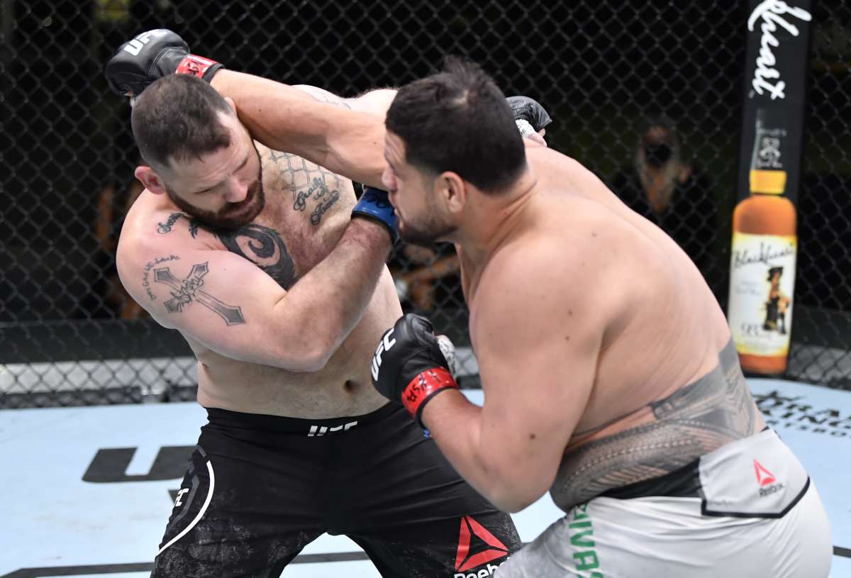 LAS VEGAS, NEVADA - MARCH 20: (R-L) Tai Tuivasa of Australia punches Harry Hunsucker in their heavyweight fight during the UFC Fight Night event at UFC APEX on March 20, 2021 in Las Vegas, Nevada. (Photo by Chris Unger/Zuffa LLC via Getty Images)