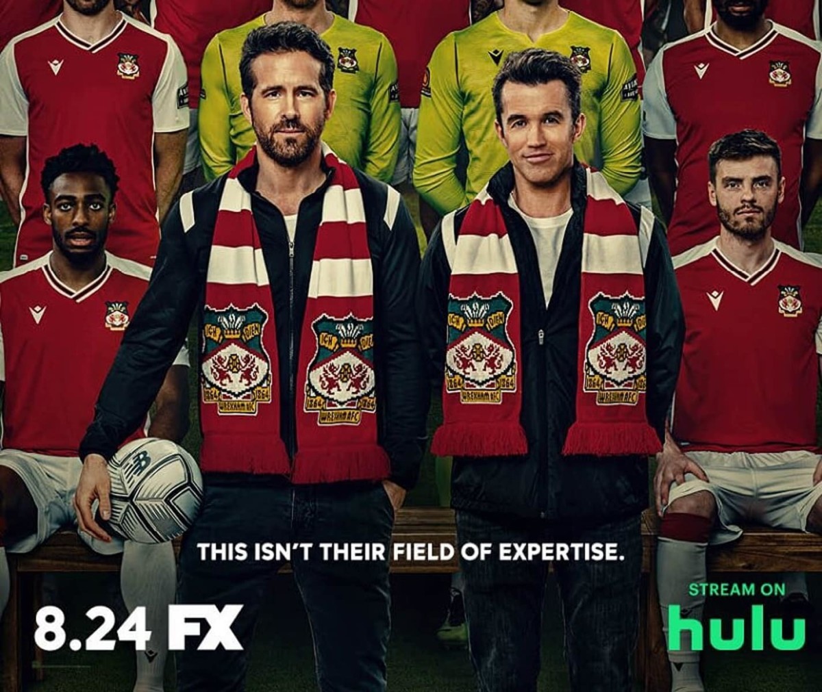 Welcome to Wrexham cover photo showing Ryan Reynolds and Rob McElhenney alondside the team