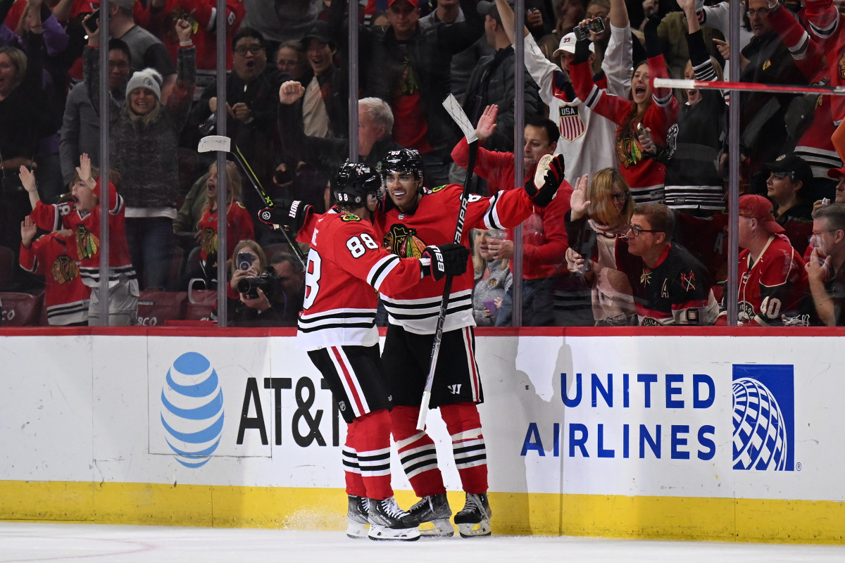 Chicago Blackhawks center Kirby Dach, right, celebrates his tying