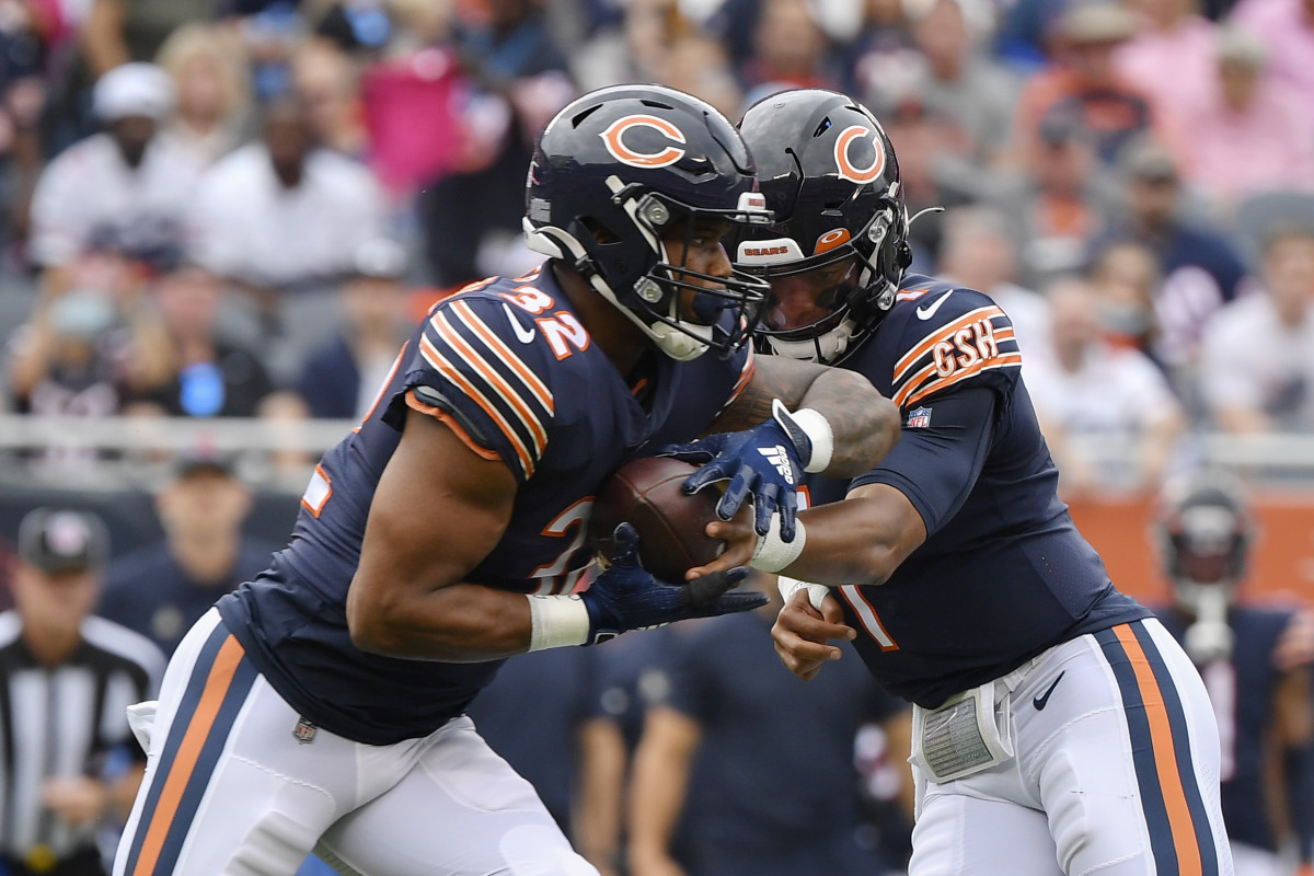 Oct 3, 2021; Chicago, Illinois, USA; Chicago Bears quarterback Justin Fields (1) hands the ball off to Chicago Bears running back David Montgomery (32) in the first half against the Detroit Lions at Soldier Field.