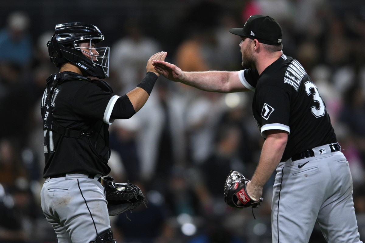 Sep 30, 2022; San Diego, California, USA; Chicago White Sox catcher Carlos Perez (21) and relief pitcher Liam Hendriks (31) celebrate on the field after defeating the San Diego Padres at Petco Park.